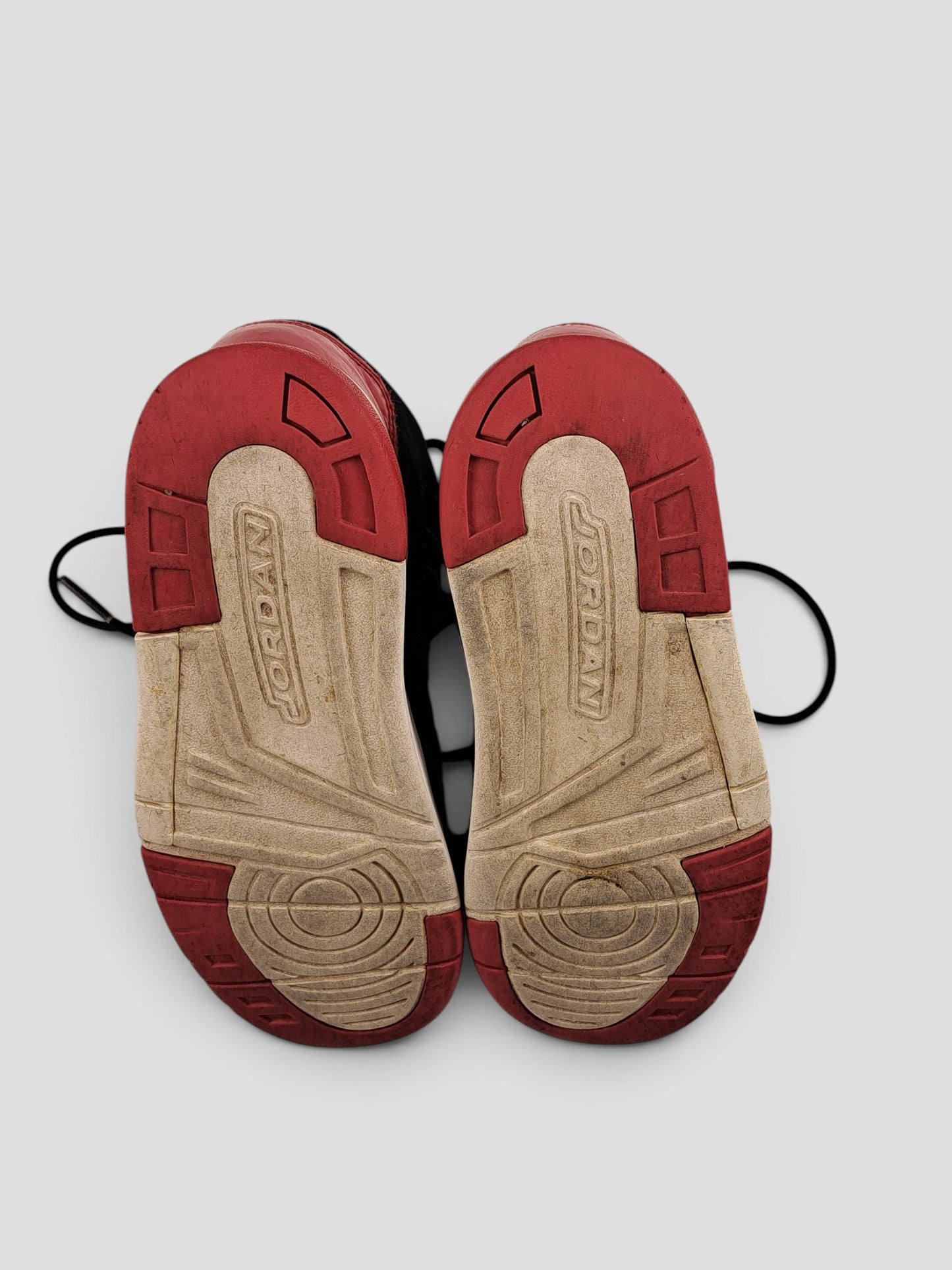 BaraBarnet Jordan sneakers showing the red and white rubber outsoles with Jordan branding