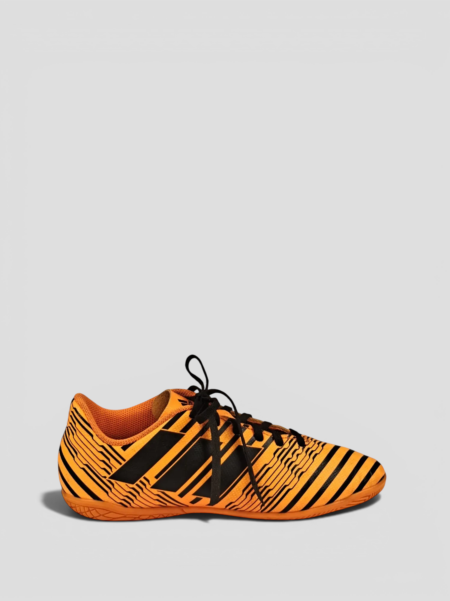 BaraBarnet Adidas indoor soccer shoes in orange and black with a striped pattern and lace-up closure.