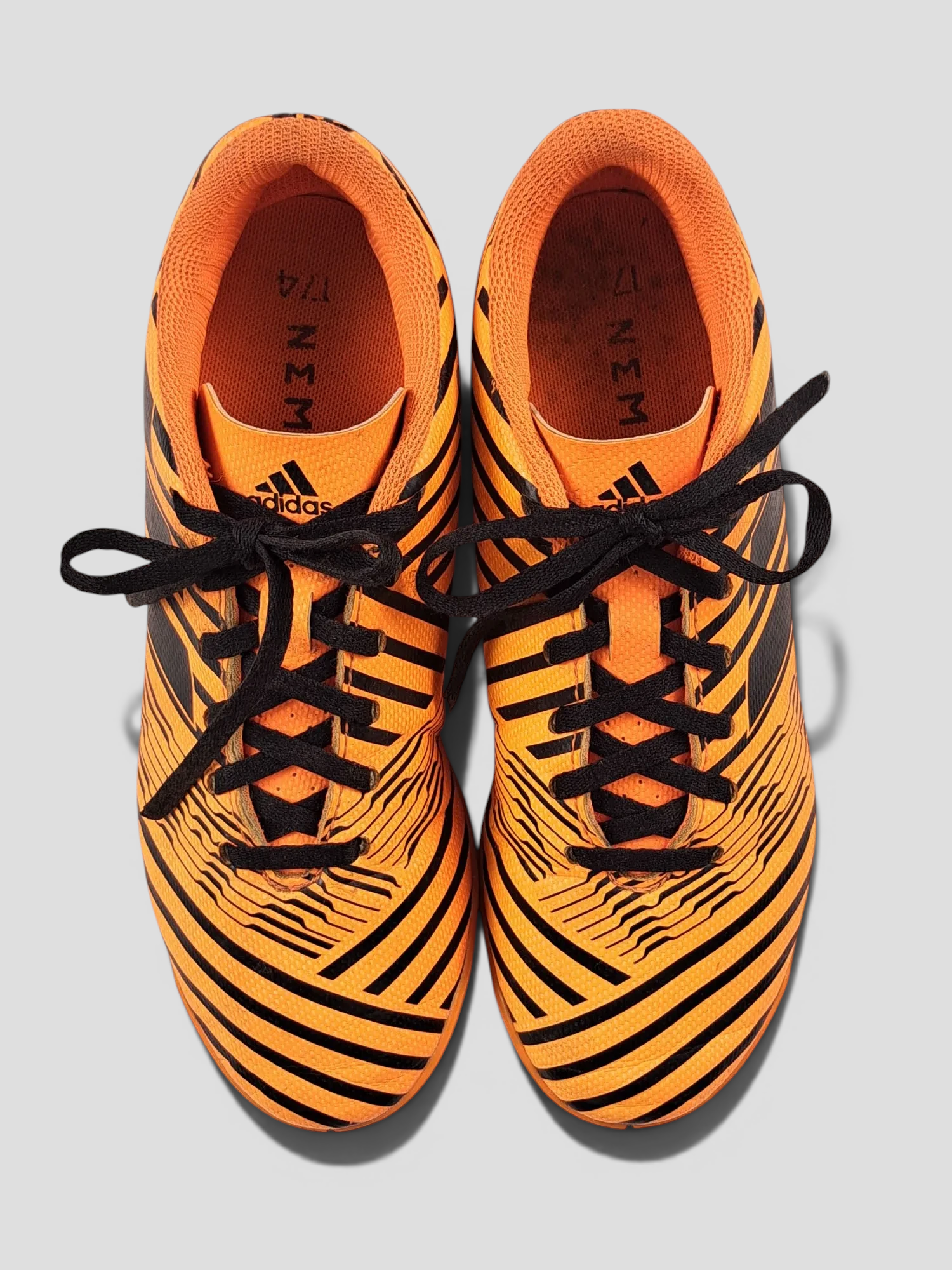 BaraBarnet Adidas Nemeziz indoor soccer shoes in orange and black with a striped pattern and black laces
