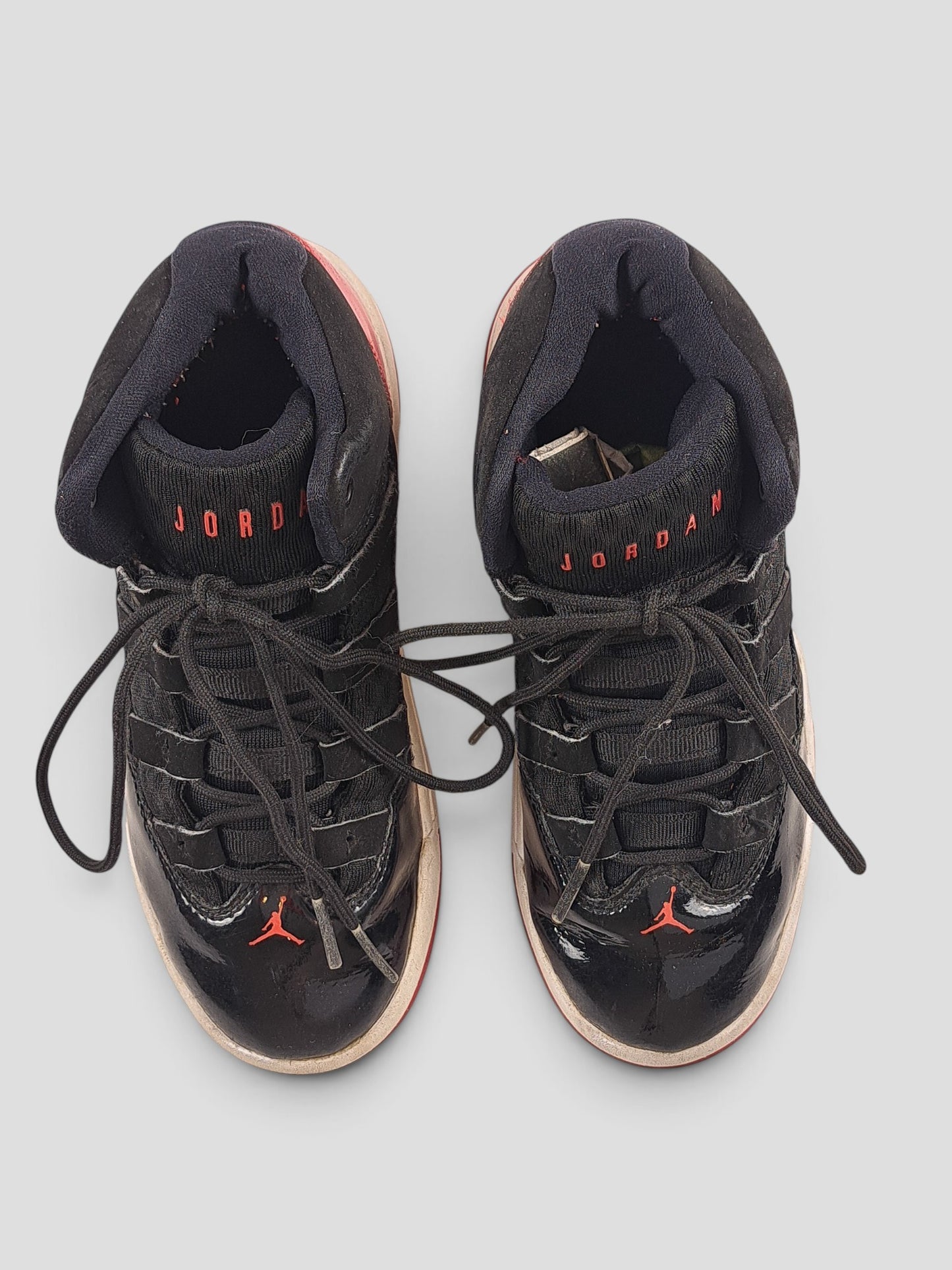 BaraBarnet Jordan black patent leather sneakers with red accents and lace-up closure viewed from above