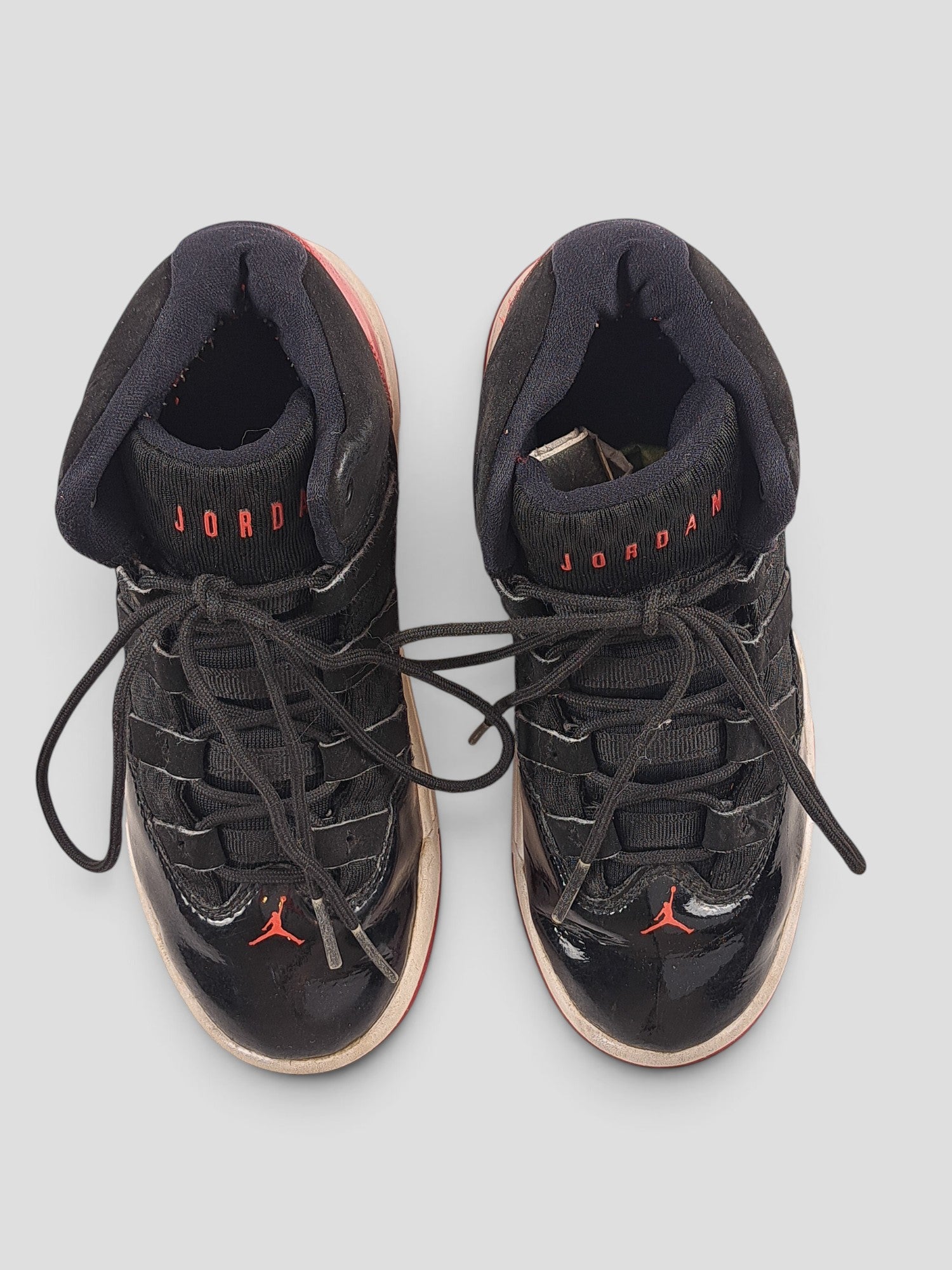 BaraBarnet Jordan black patent leather sneakers with red accents and lace-up closure viewed from above