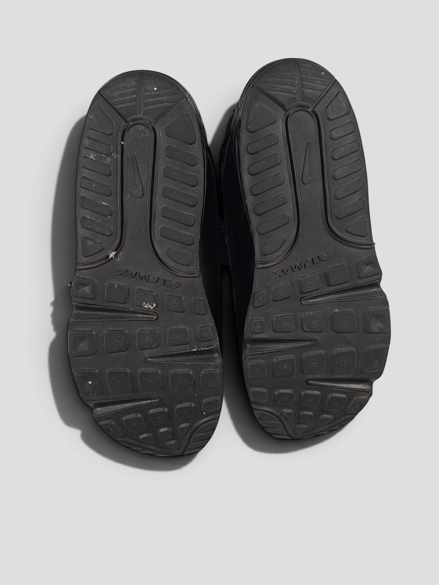BaraBarnet Nike black sneakers showing the textured rubber outsoles with Air Max branding