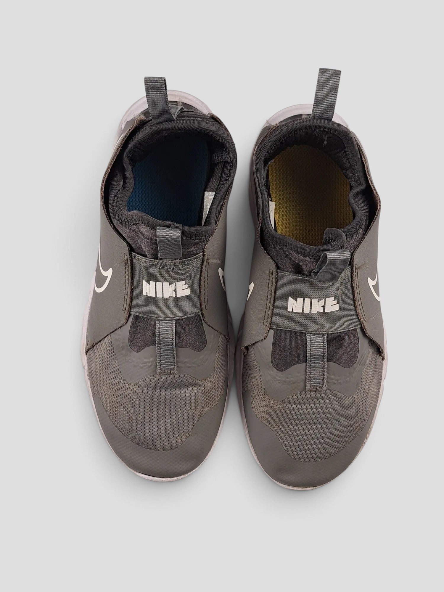 BaraBarnet Nike grey slip-on sneakers with white swoosh logo and pull tabs