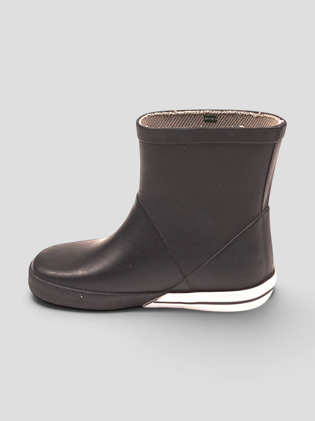 BaraBarnet Tretorn black rubber boots with a white midsole and soft textile lining, side view