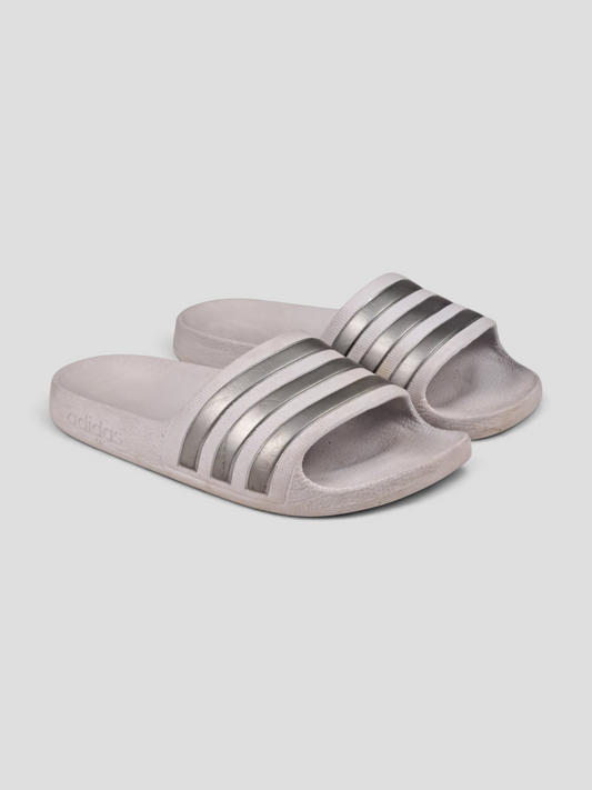 BaraBarnet white Adidas slides with three metallic silver stripes and embossed logo on the sole