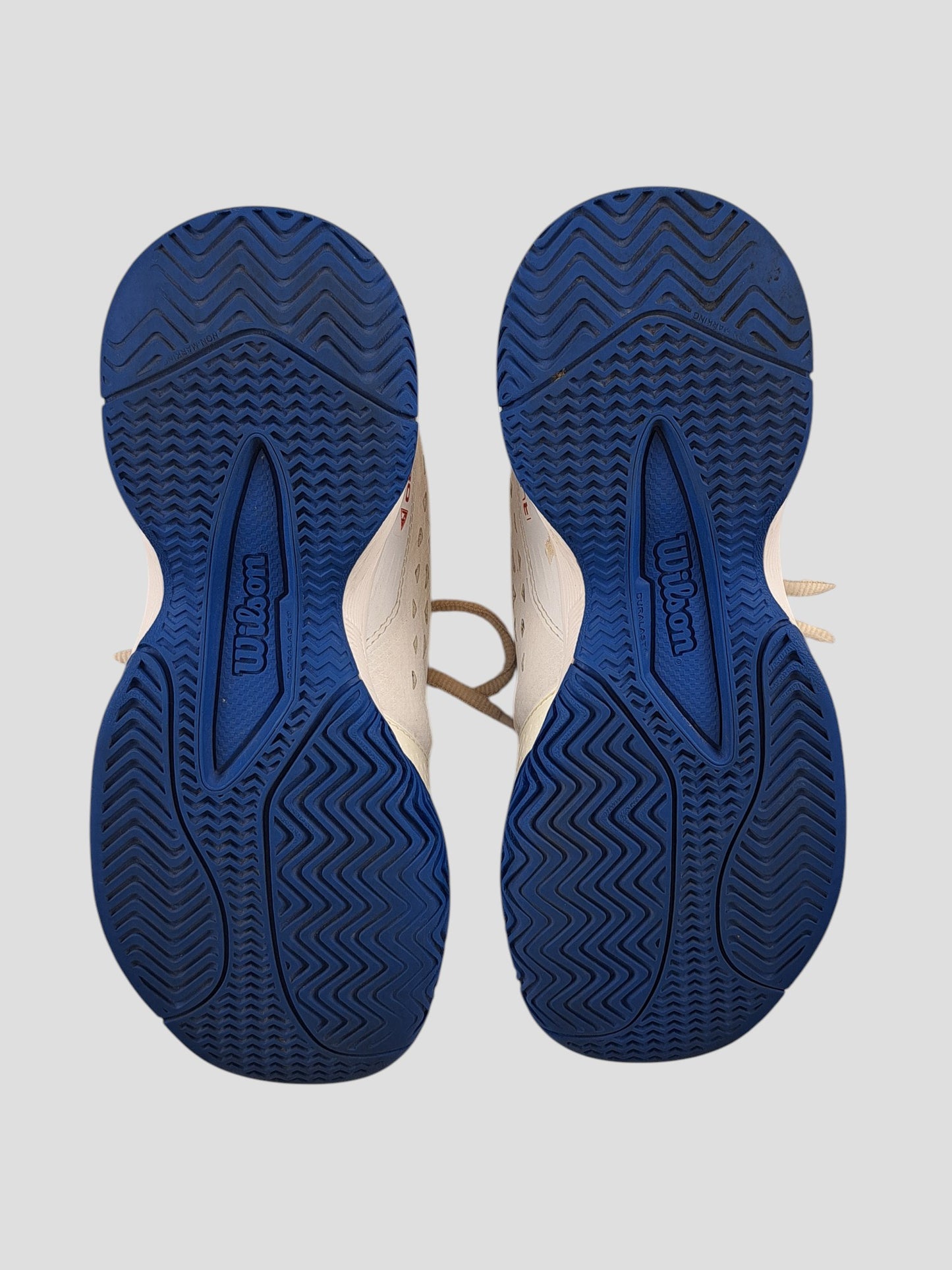 BaraBarnet Wilson RushPro tennis shoes featuring white uppers and blue non-marking herringbone outsoles